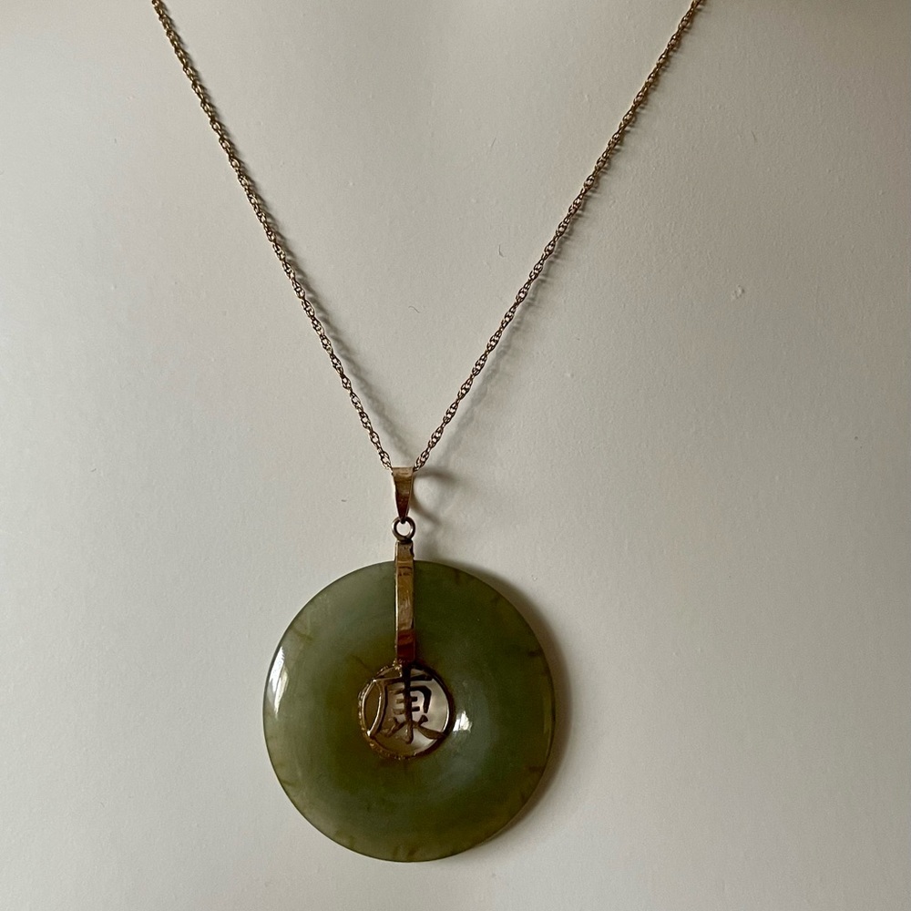 This is a vintage green jade 14K pendant Chinese character. Pendant only.